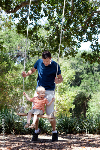father and son on a swing