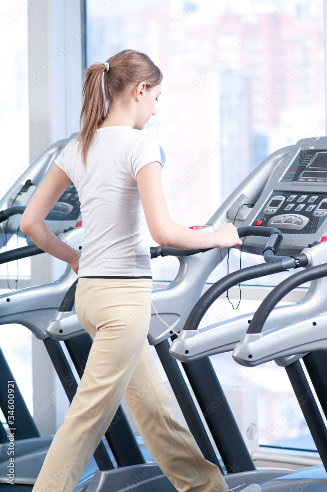 Young woman at the gym exercising. Running Young woman at the gym exercising. Running