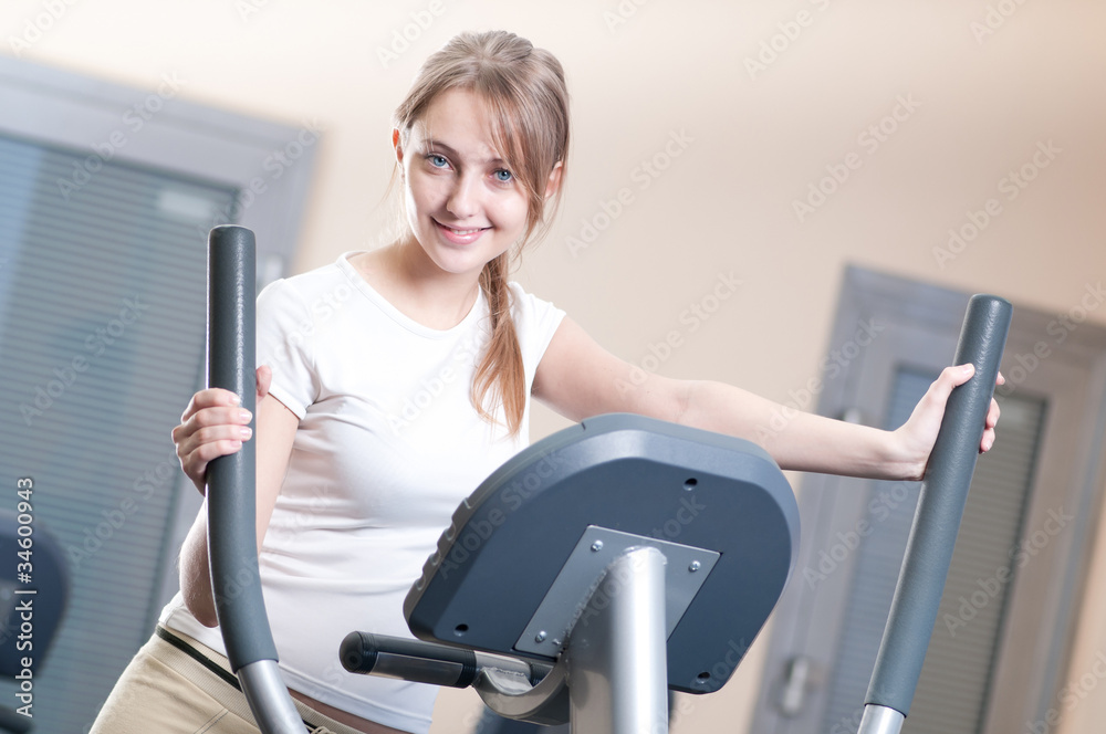 Young woman at the gym exercising. Running Young woman at the gym exercising. Running