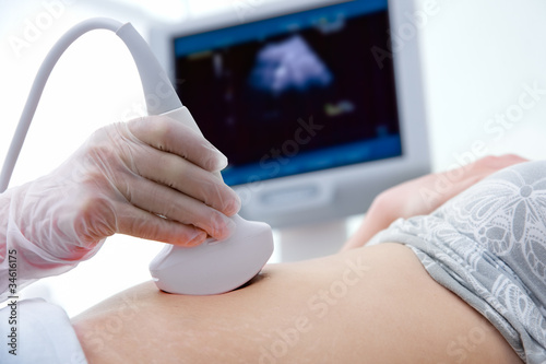 woman getting ultrasound diagnostic from doctor photo