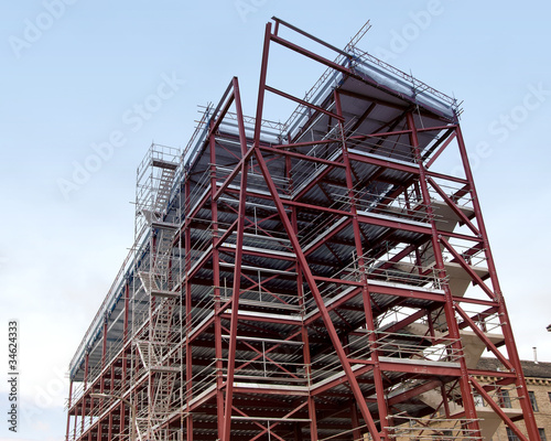 A Red Painted Steel Framed Building under a blue sky
