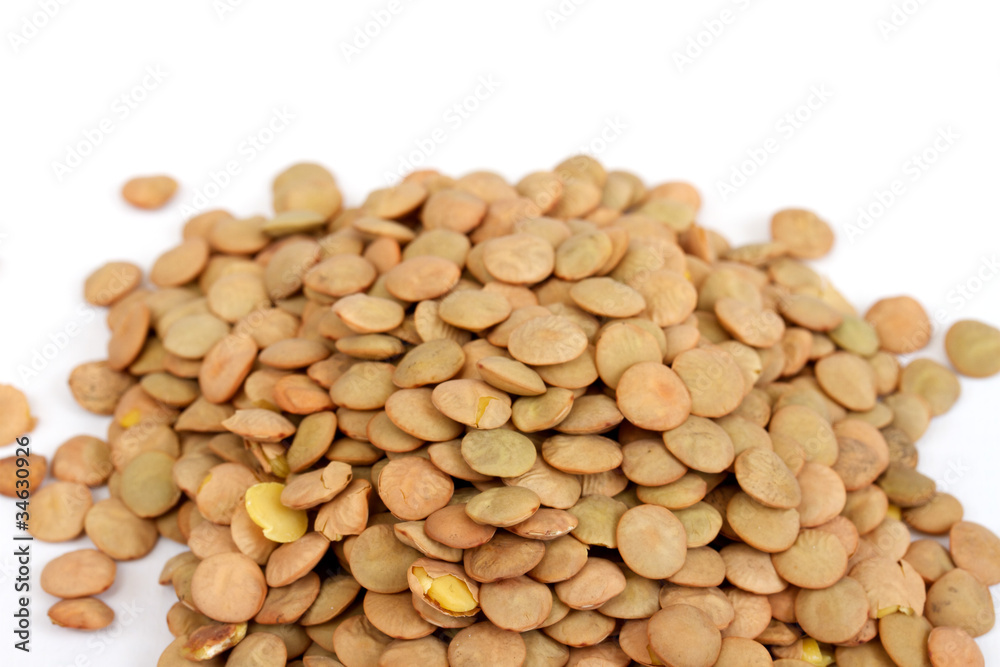 Pile of green lentils from low perspective isolated on white. Pile of green lentils from low perspective isolated on white.
