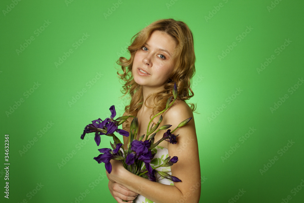 Attractive girl hugging a bouquet of iris Attractive girl hugging a bouquet of iris