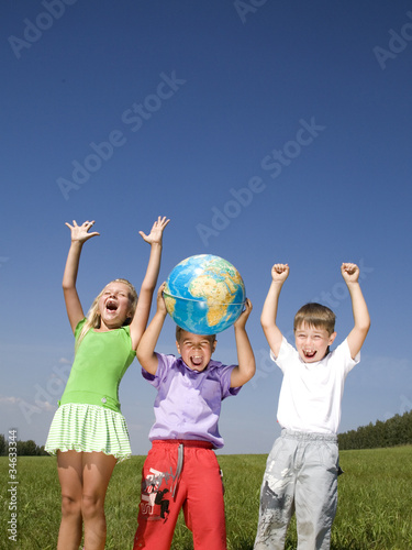 Image of joyful schoolchildren raising their hands