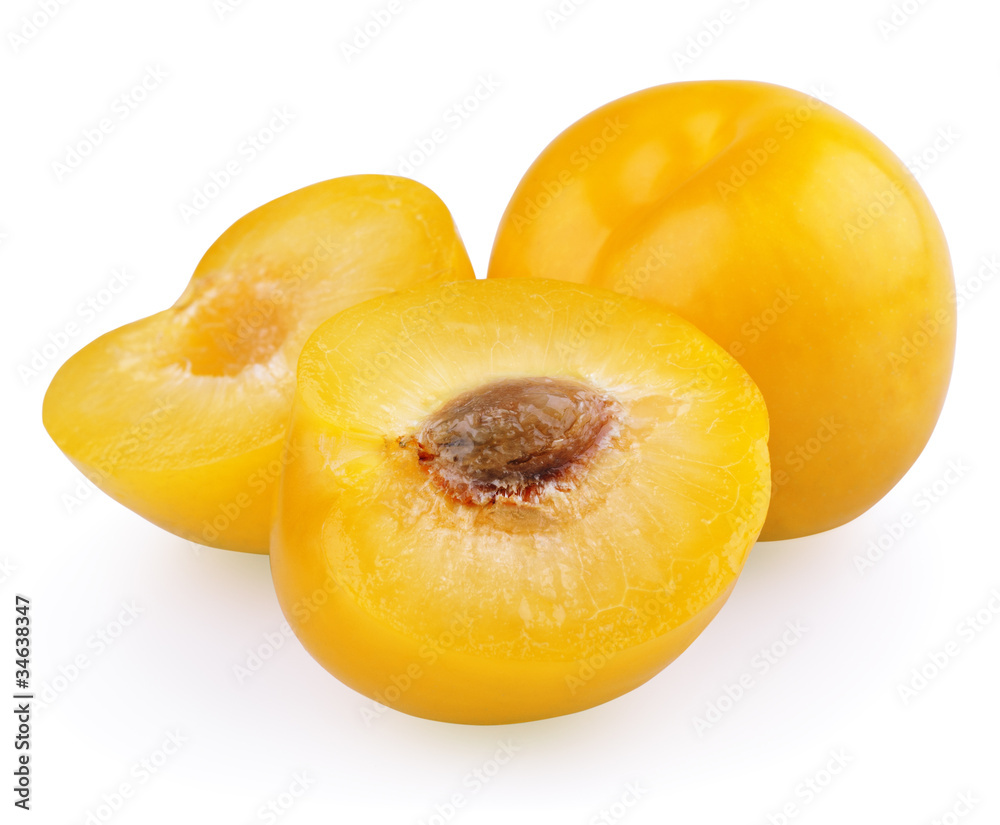Yellow plum with halves isolated on white background