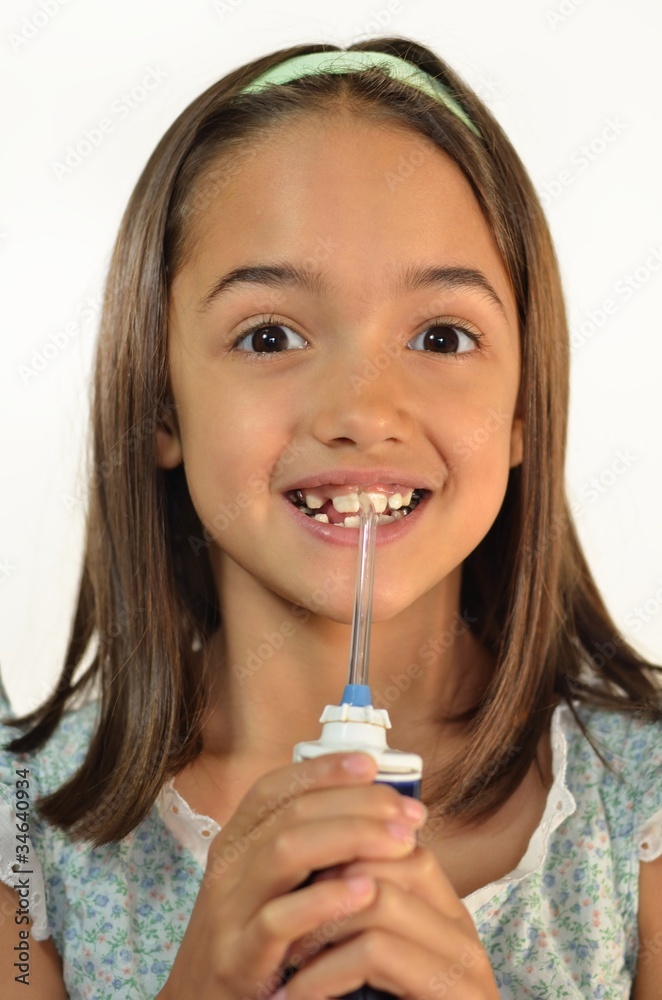 Girl cleaning her teeth with a water pick Girl cleaning her teeth with a water pick