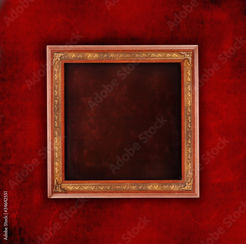 Dark, rough wall with a gold frame
