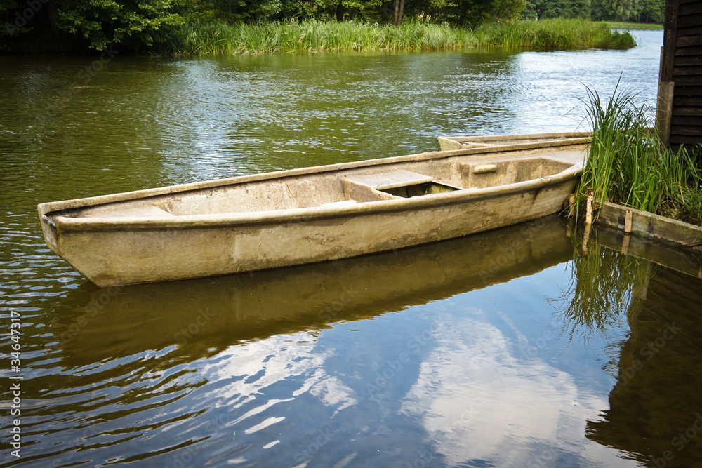 Vintage fishing boat in the lake at summer