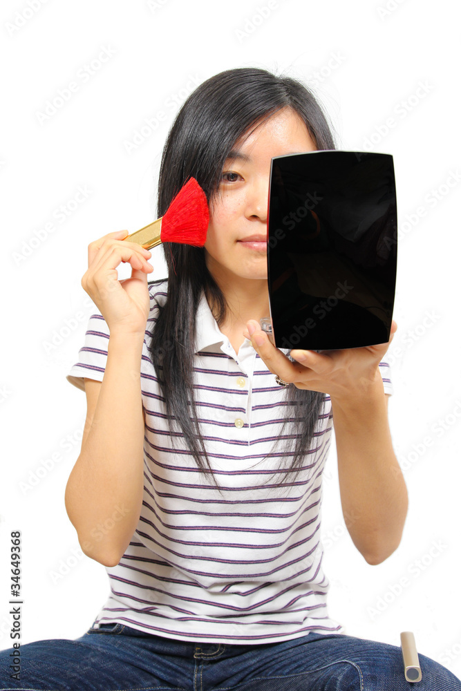 Young chinese woman putting on makeup Young chinese woman putting on makeup