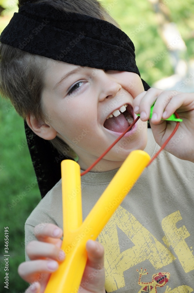 A boy plays with a left-handed catapult A boy plays with a left-handed catapult