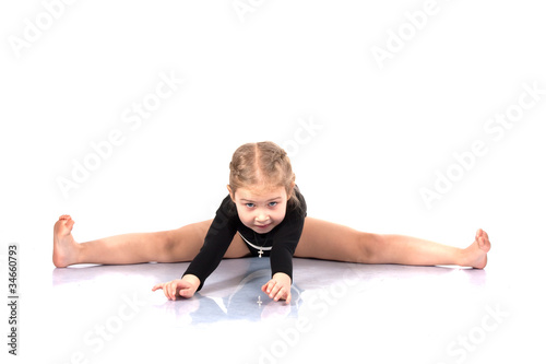 Studio portrait of girl gymnasts, stretching