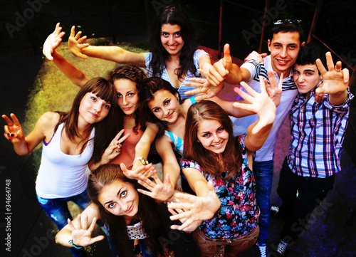 A group of young people dancing at a disco.