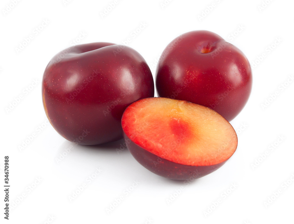 fresh plums on white background