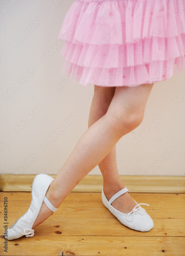 Yound ballerina's legs and feet in pink tutu dress Yound ballerina's legs and feet in pink tutu dress