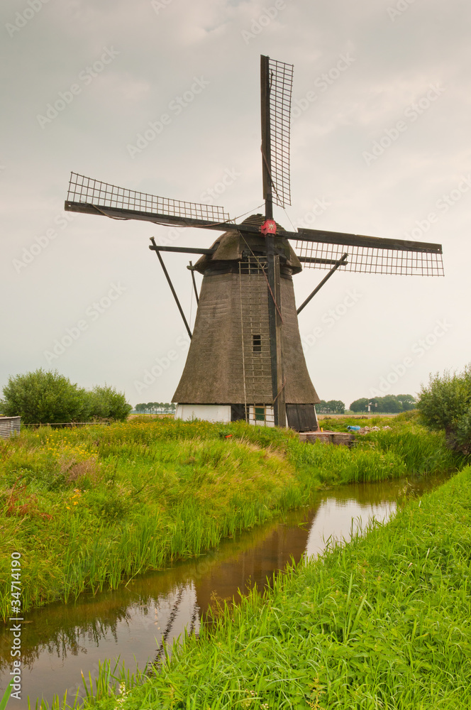 Dutch windmill (anno 1700) along a reflecting ditch