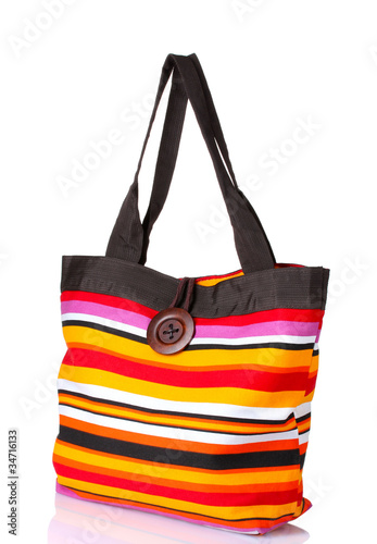 bright striped beach bag isolated on white