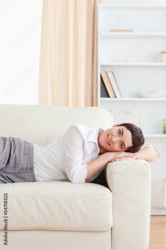 Smiling Woman lying on a sofa Smiling Woman lying on a sofa