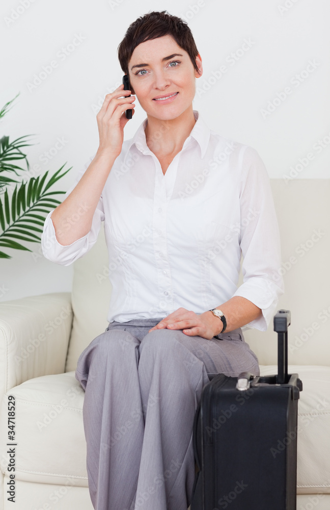 Woman with a suitcase and a phone Woman with a suitcase and a phone