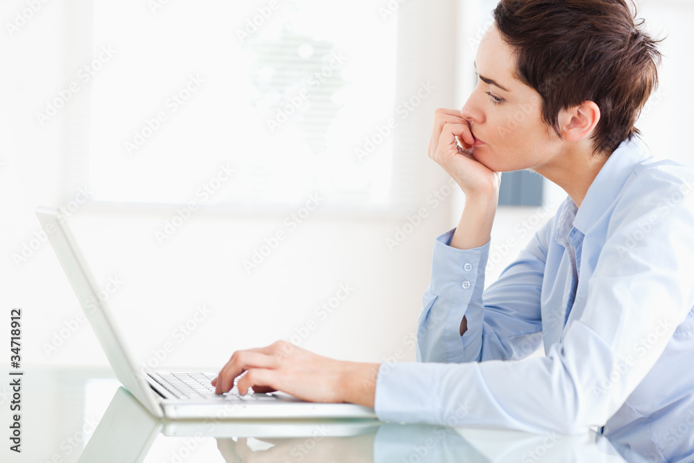 Bored short-haired businesswoman with a laptop Bored short-haired businesswoman with a laptop