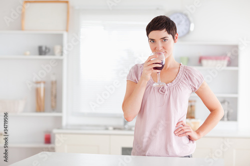Joyful woman drinking wine