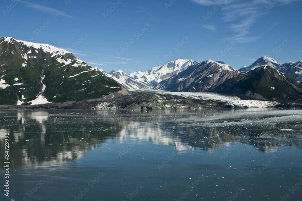 Wide shot on glacier reaching the sea in Alaska.