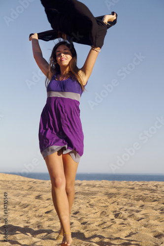 playful beautiful young girl with purple dress