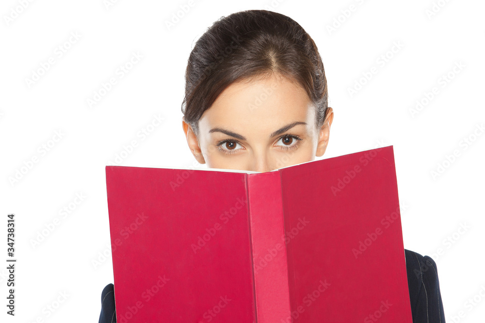Close-up portrait of female peeking over the book Close-up portrait of female peeking over the book