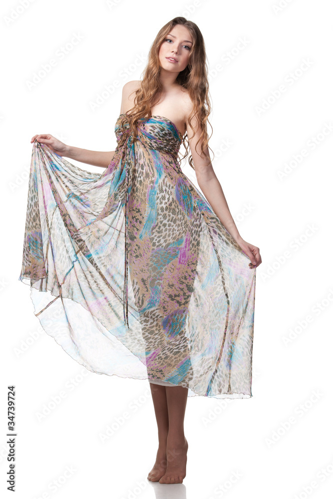 Full-body portrait of young charming female in chiffon dress