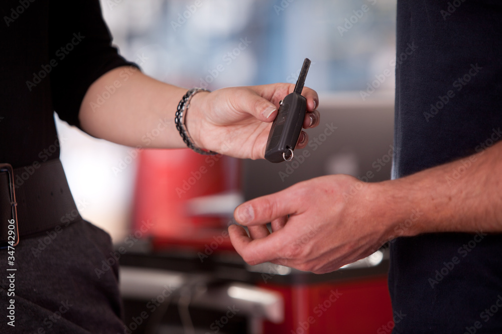 Woman Delivering Key to mechanic Woman Delivering Key to mechanic