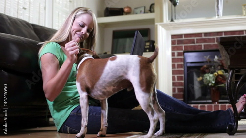 Happy Owner of Jack-Rat Terrier Dog Working on Laptop