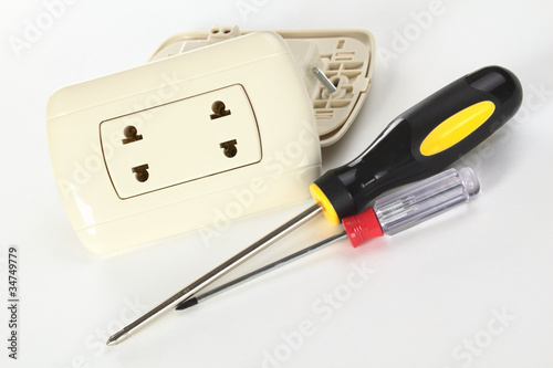 Two plastic sockets with philipshead screwdrivers on white photo