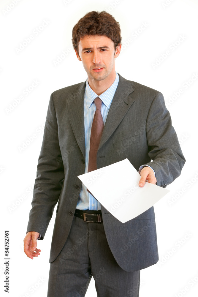 Displeased modern businessman showing document Displeased modern businessman showing document