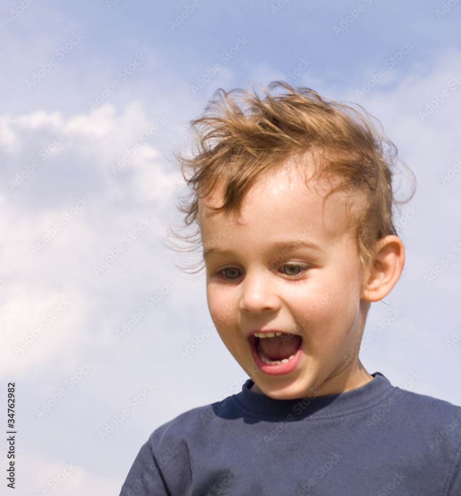 happy little boy on the sky background