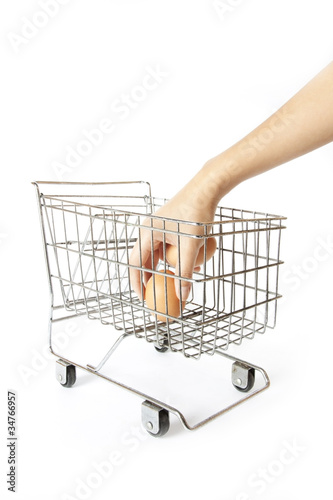 buy egg, hand put one egg into silver supermarket trolley.