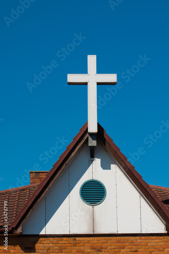 white cross a symbol of hope against blue sky