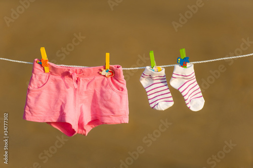 Shorts and socks are drying on a line with