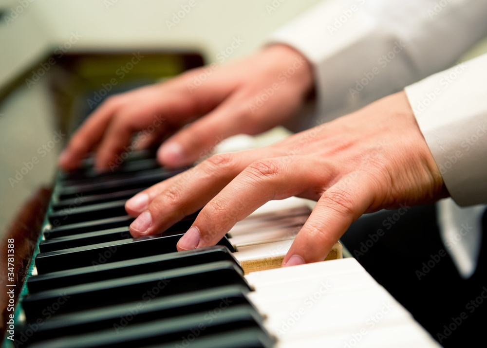 Fototapeta premium Male hands playing the piano