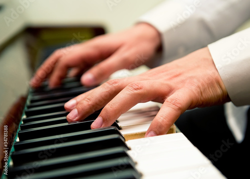 Male hands playing the piano