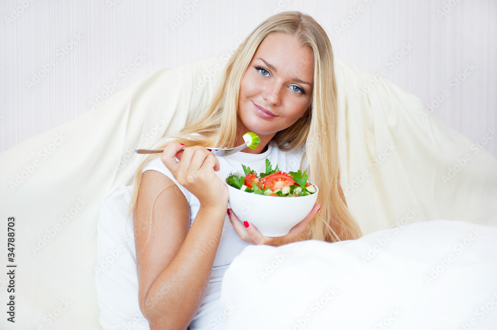 Closeup portrait of a beautiful slender girl eating healthy food Closeup portrait of a beautiful slender girl eating healthy food