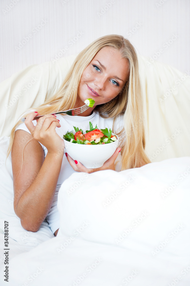 Closeup portrait of a beautiful slender girl eating healthy food Closeup portrait of a beautiful slender girl eating healthy food