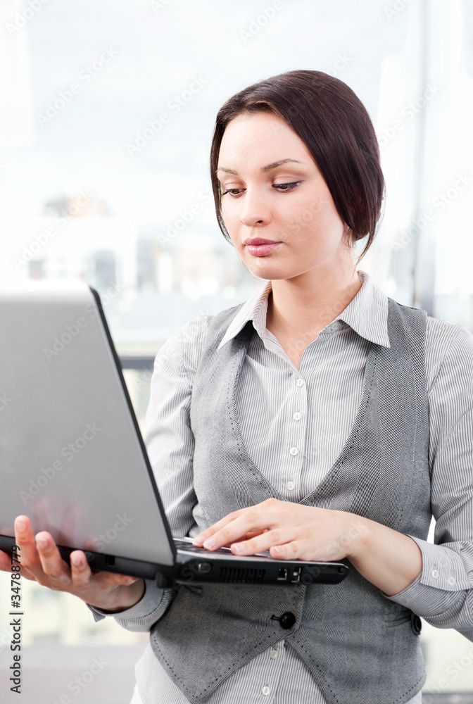 Beautiful business woman concentrating while working on computer Beautiful business woman concentrating while working on computer