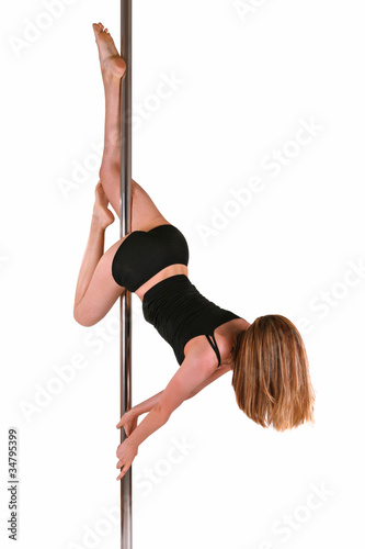 Young woman exercising pole dance fitness