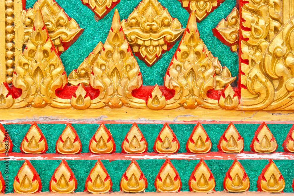 Golden Thai pattern design on temple pillar