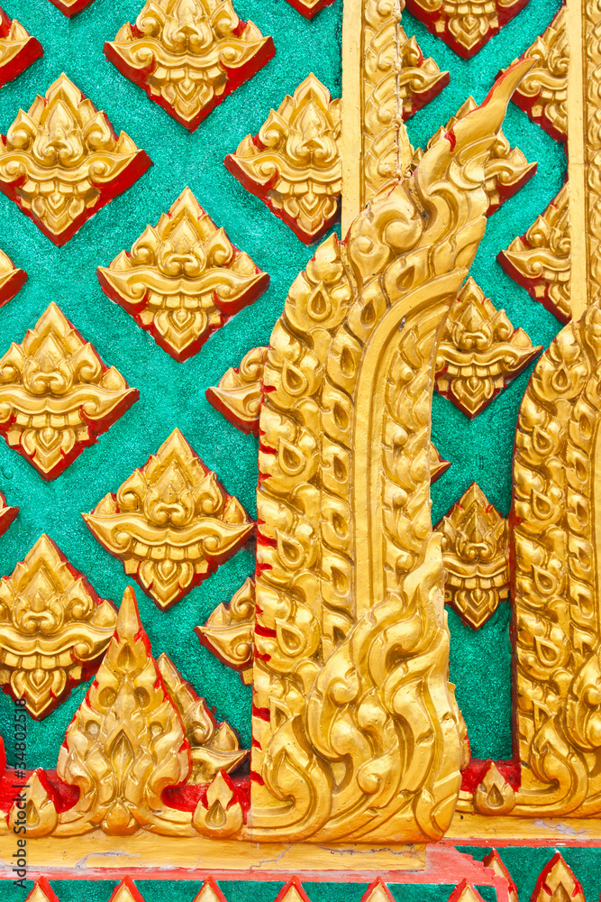 Golden Thai pattern design on temple pillar
