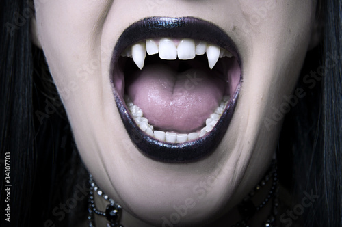 Opened vampire woman mouth closeup