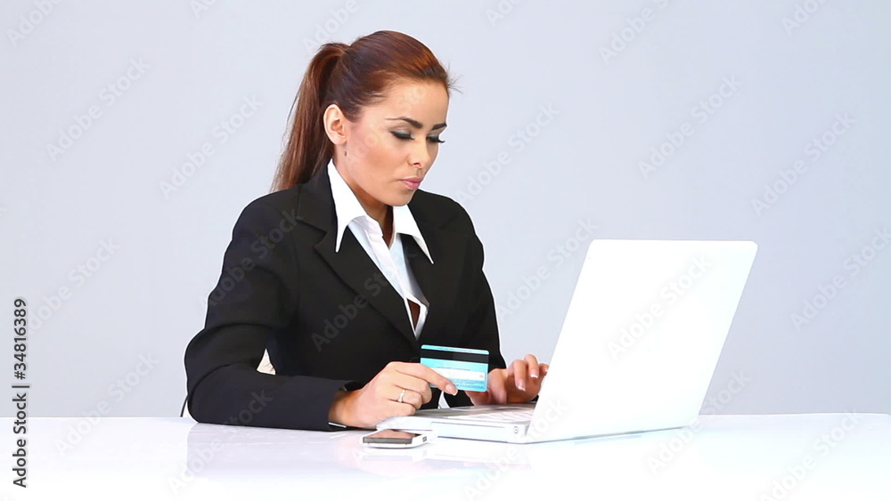 Beautiful business woman using credit card and paying online Beautiful business woman using credit card and paying online