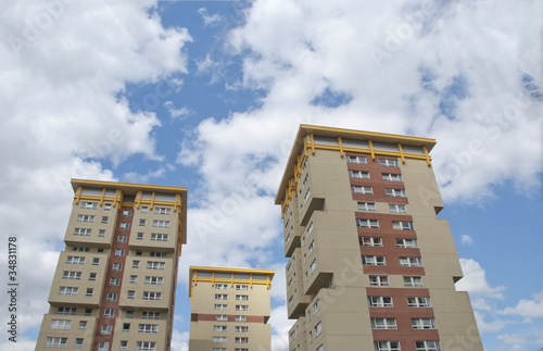 Three Yellow and Cream Apartments under a summer sky photo