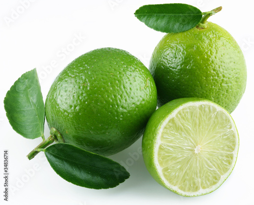 Lime with leaves on white background.