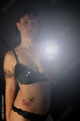 A Female Brunette Model Holding A Glowing Orb With Lens Flare