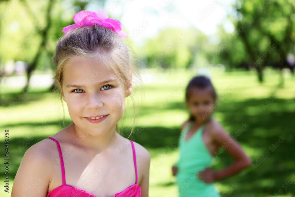 Little girl in summer park with friends Little girl in summer park with friends